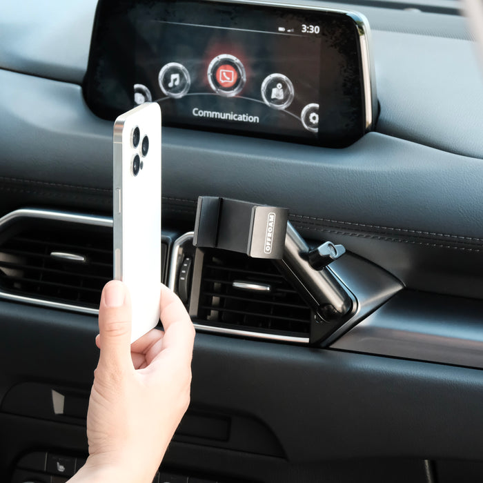 Image of Offroam Phone Mount installed securely in Mazda CX-5 2017-2025. This premium phone mount installs easily without drilling or glue. Spring loaded Universal holder for use with any phone. Perfect placement without blocking screens, driver view, or air flow. Fully adjustable positioning.
