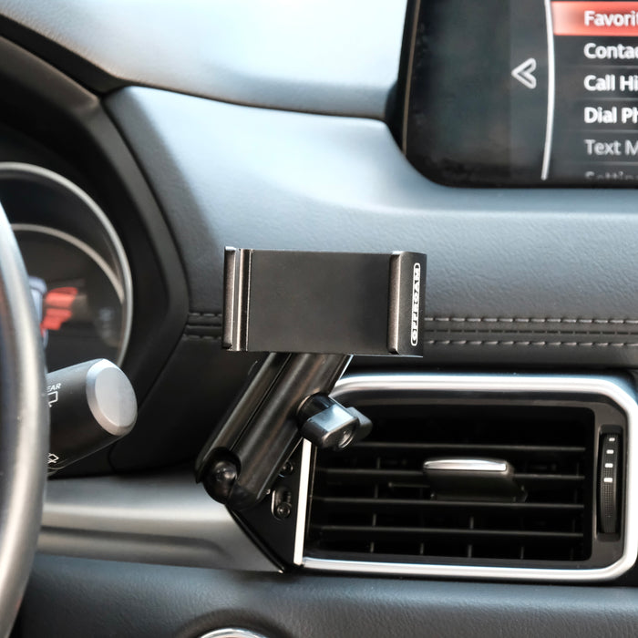 Image of Offroam Phone Mount installed securely in Mazda CX-5 2017-2025. This premium phone mount installs easily without drilling or glue. Spring loaded Universal holder for use with any phone. Perfect placement without blocking screens, driver view, or air flow. Fully adjustable positioning.