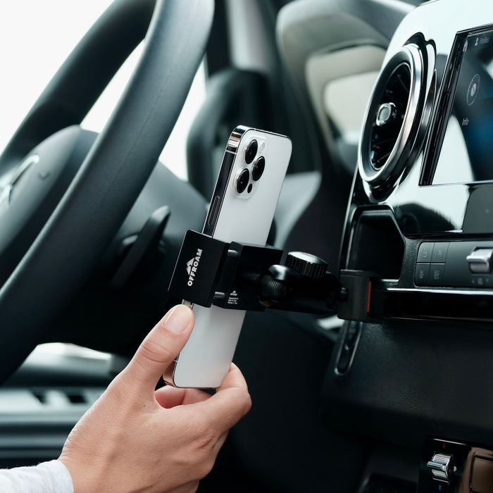 Image of Offroam Phone Mount installed securely in Mercedes-Benz Sprinter 2019-2026. This premium phone mount installs easily without drilling or glue. Spring loaded Universal holder for use with any phone. Perfect placement without blocking screens, driver view, or air flow. Fully adjustable positioning.
