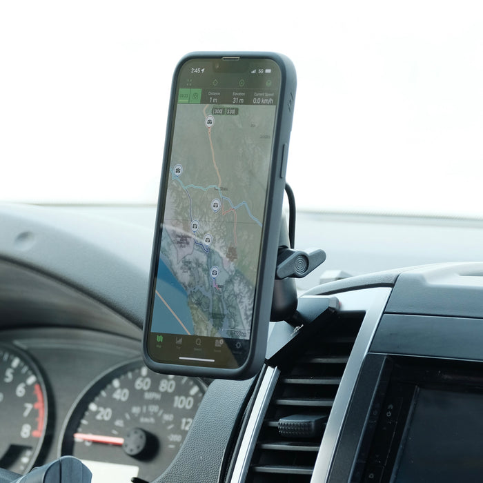 Image of Offroam MagSafe-compatible Qi2 Charging Phone Mount installed securely in Nissan Frontier 2009-2021 | Xterra 2009-2015. This premium phone mount installs easily without drilling or glue. High force magnets hold phone on any trail, road, or track. Qi2 fast wireless charging. Perfect placement without blocking screens, driver view, or air flow. Fully adjustable positioning.