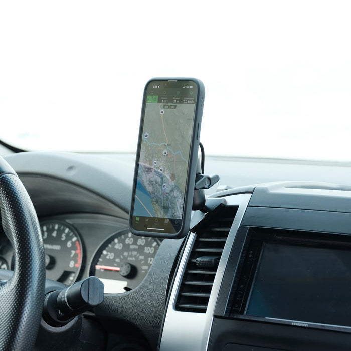 Image of Offroam MagSafe-compatible Phone Mount installed securely in Nissan Frontier 2009-2021 | Xterra 2009-2015. This premium phone mount installs easily without drilling or glue. High force magnets hold phone on any trail, road, or track. Perfect placement without blocking screens, driver view, or air flow. Fully adjustable positioning.