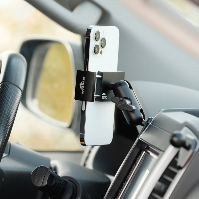 Image of Offroam Phone Mount installed securely in Nissan Frontier 2009-2021 | Xterra 2009-2015. This premium phone mount installs easily without drilling or glue. Spring loaded Universal holder for use with any phone. Perfect placement without blocking screens, driver view, or air flow. Fully adjustable positioning.