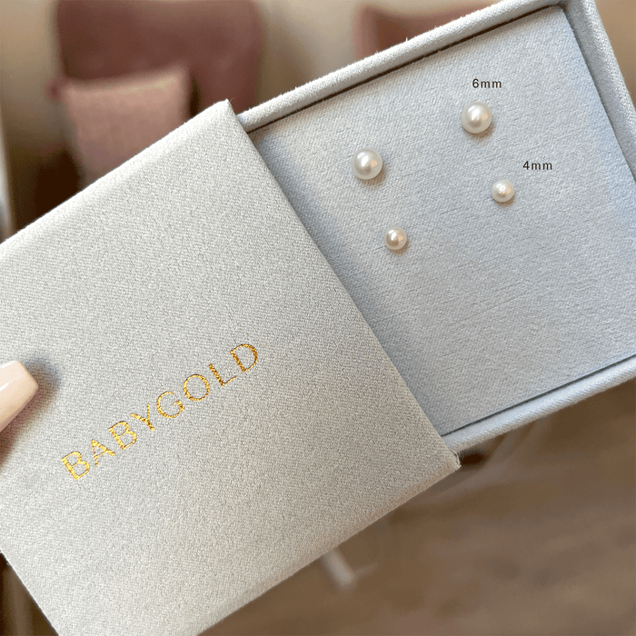 One pair of 6mm pearl stud earrings and one pair of 4mm pearl stud earrings in blue jewelry box.