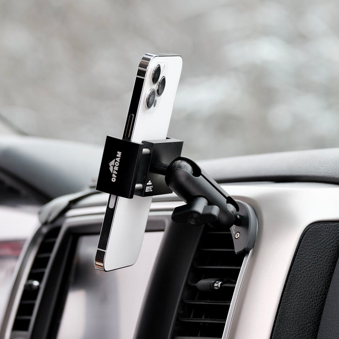 Image of Offroam Phone Mount installed securely in Ram 1500/2500/3500 2013-2018 & Ram Classic 2019-2024. This premium phone mount installs easily without drilling or glue. Spring loaded Universal holder for use with any phone. Perfect placement without blocking screens, driver view, or air flow. Fully adjustable positioning.