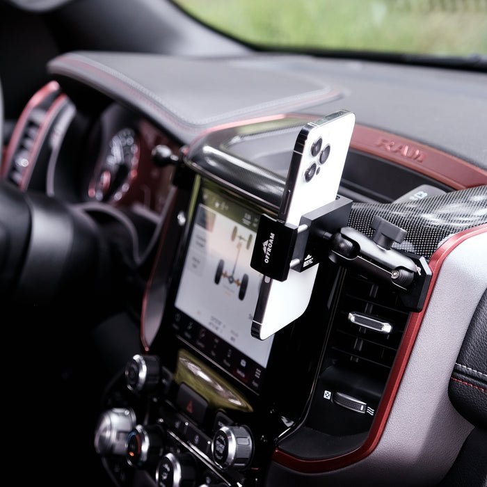 Image of Offroam Phone Mount installed securely in Ram 1500/2500/3500 2019-2026. This premium phone mount installs easily without drilling or glue. Spring loaded Universal holder for use with any phone. Perfect placement without blocking screens, driver view, or air flow. Fully adjustable positioning.