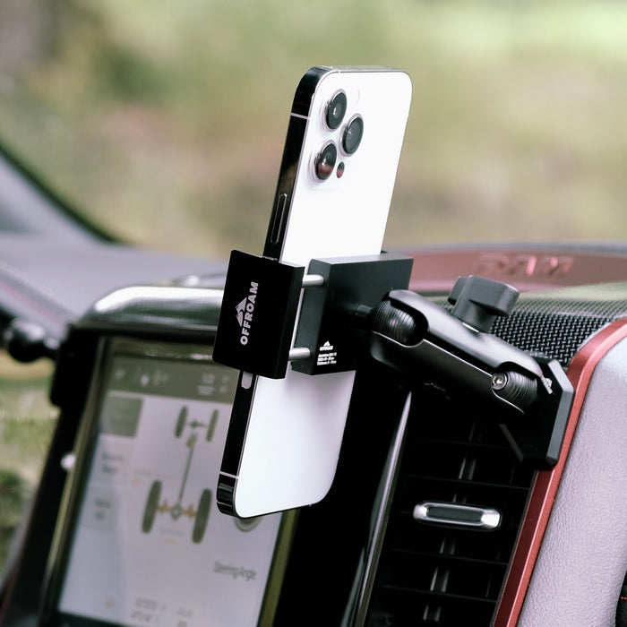 Image of Offroam Phone Mount installed securely in Ram 1500/2500/3500 2019-2026. This premium phone mount installs easily without drilling or glue. Spring loaded Universal holder for use with any phone. Perfect placement without blocking screens, driver view, or air flow. Fully adjustable positioning.