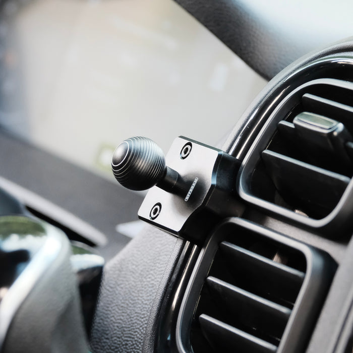 Image of Offroam Mounting Base installed securely in RAM ProMaster 2022-2026. This premium all metal phone mounting base installs easily without drilling or glue. Perfect placement without blocking screens, driver view, or air flow.