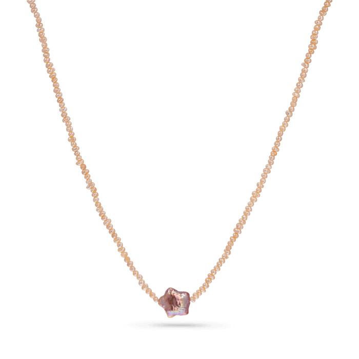 A strand necklace of micro pink pearls with a star shaped purple pearl in the center.