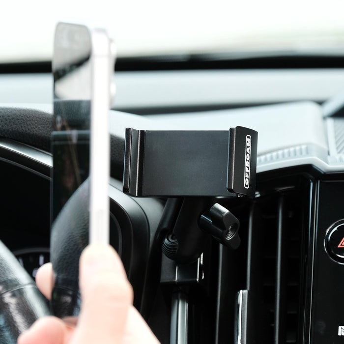Image of Offroam Phone Mount installed securely in Subaru Ascent 2023-2026. This premium phone mount installs easily without drilling or glue. Spring loaded Universal holder for use with any phone. Perfect placement without blocking screens, driver view, or air flow. Fully adjustable positioning.