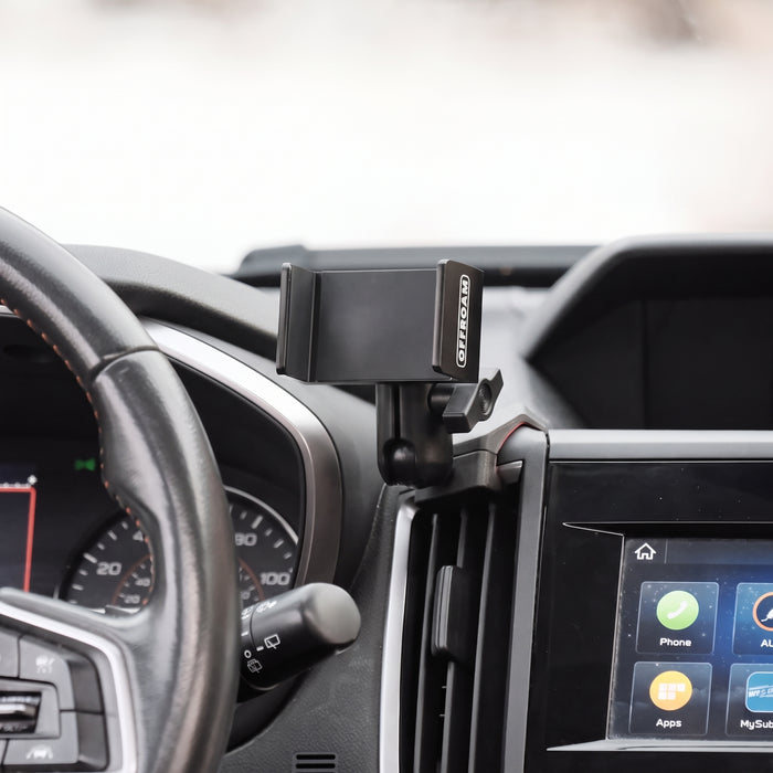 Image of Offroam Phone Mount installed securely in Subaru Crosstrek 2018-2023 | Forester 2019-2024| Impreza 2017-2023. This premium phone mount installs easily without drilling or glue. Spring loaded Universal holder for use with any phone. Perfect placement without blocking screens, driver view, or air flow. Fully adjustable positioning.