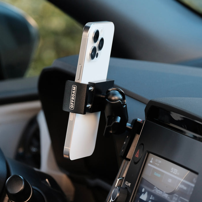 Image of Offroam Phone Mount installed securely in Subaru Forester 2025-2026. This premium phone mount installs easily without drilling or glue. Spring loaded Universal holder for use with any phone. Perfect placement without blocking screens, driver view, or air flow. Fully adjustable positioning.