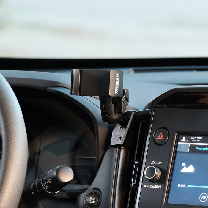 Image of Offroam Phone Mount installed securely in Subaru Forester 2025-2026. This premium phone mount installs easily without drilling or glue. Spring loaded Universal holder for use with any phone. Perfect placement without blocking screens, driver view, or air flow. Fully adjustable positioning.