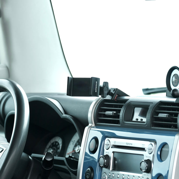 Image of Offroam Phone Mount installed securely in Toyota FJ Cruiser 2007-2014. This premium phone mount installs easily without drilling or glue. Spring loaded Universal holder for use with any phone. Perfect placement without blocking screens, driver view, or air flow. Fully adjustable positioning.