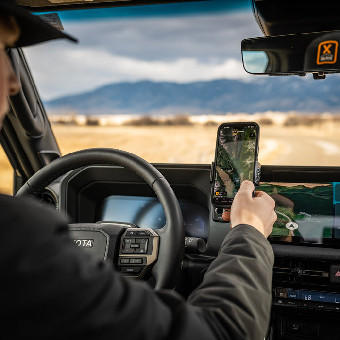 Image of Offroam Phone Mount XOVERLAND Edition installed securely in Toyota Land Cruiser 250 2024-2027. This premium phone mount installs easily without drilling or glue. Spring loaded Universal holder for use with any phone. Perfect placement without blocking screens, driver view, or air flow. Fully adjustable positioning.