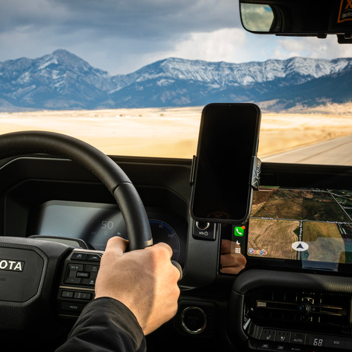 Image of Offroam Phone Mount XOVERLAND Edition installed securely in Toyota Land Cruiser 250 2024-2027. This premium phone mount installs easily without drilling or glue. Spring loaded Universal holder for use with any phone. Perfect placement without blocking screens, driver view, or air flow. Fully adjustable positioning.