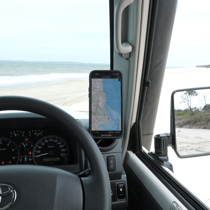 Image of Offroam MagSafe-compatible Phone Mount installed securely in Toyota Land Cruiser 70 2007-2026. This premium phone mount installs easily without drilling or glue. High force magnets hold phone on any trail, road, or track. Perfect placement without blocking screens, driver view, or air flow. Fully adjustable positioning.