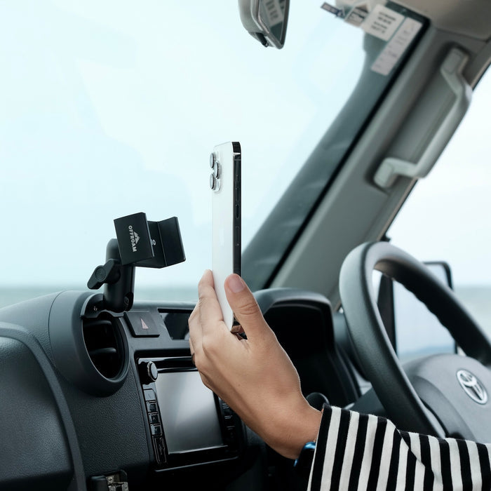 Image of Offroam Phone Mount installed securely in Toyota Land Cruiser 70 2007-2026. This premium phone mount installs easily without drilling or glue. Spring loaded Universal holder for use with any phone. Perfect placement without blocking screens, driver view, or air flow. Fully adjustable positioning.