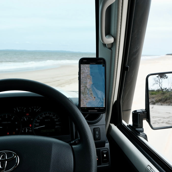 Image of Offroam Phone Mount installed securely in Toyota Land Cruiser 70 2007-2026. This premium phone mount installs easily without drilling or glue. Spring loaded Universal holder for use with any phone. Perfect placement without blocking screens, driver view, or air flow. Fully adjustable positioning.