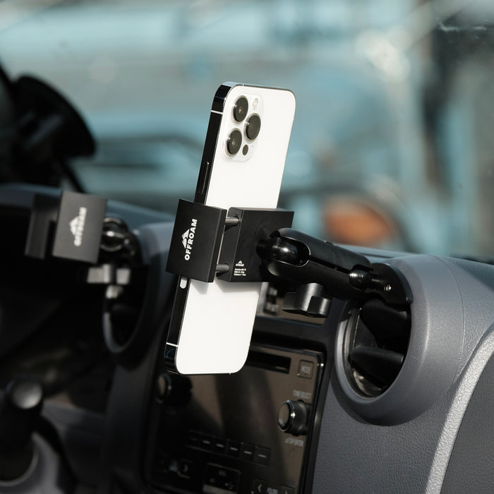 Image of Offroam Phone Mount installed securely in Toyota Land Cruiser 70 2007-2026. This premium phone mount installs easily without drilling or glue. Spring loaded Universal holder for use with any phone. Perfect placement without blocking screens, driver view, or air flow. Fully adjustable positioning.