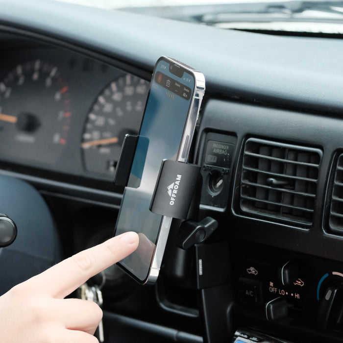 Image of Offroam Phone Mount installed securely in Toyota Tacoma 1996-2004. This premium phone mount installs easily without drilling or glue. Spring loaded Universal holder for use with any phone. Perfect placement without blocking screens, driver view, or air flow. Fully adjustable positioning.