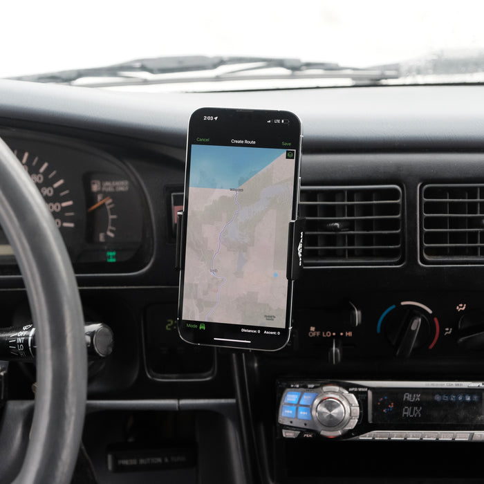 Image of Offroam Phone Mount installed securely in Toyota Tacoma 1996-2004. This premium phone mount installs easily without drilling or glue. Spring loaded Universal holder for use with any phone. Perfect placement without blocking screens, driver view, or air flow. Fully adjustable positioning.