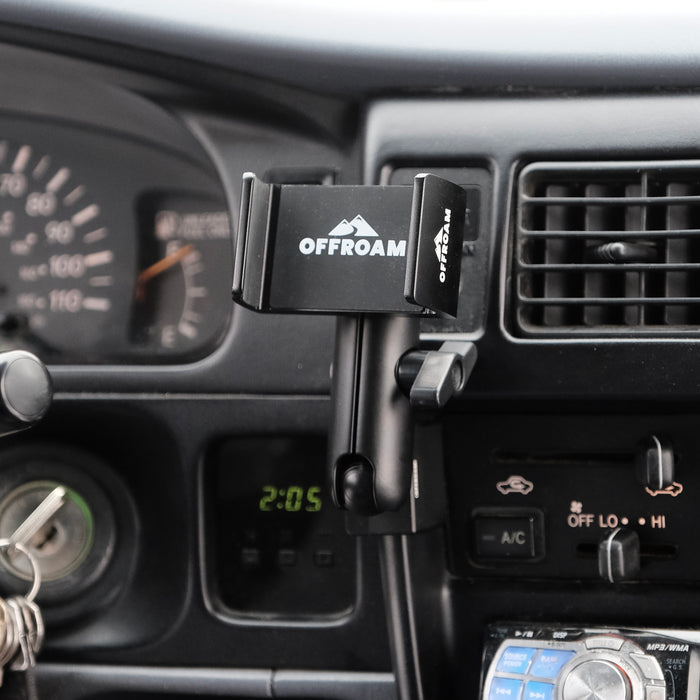 Image of Offroam Phone Mount installed securely in Toyota Tacoma 1996-2004. This premium phone mount installs easily without drilling or glue. Spring loaded Universal holder for use with any phone. Perfect placement without blocking screens, driver view, or air flow. Fully adjustable positioning.