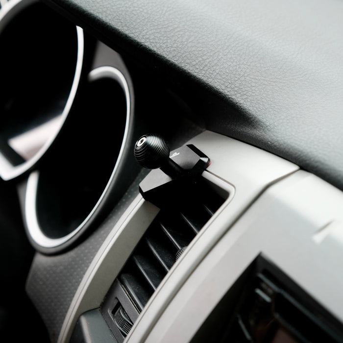 Image of Offroam MagSafe-compatible Phone Mount installed securely in Toyota Tacoma 2005-2011. This premium phone mount installs easily without drilling or glue. High force magnets hold phone on any trail, road, or track. Perfect placement without blocking screens, driver view, or air flow. Fully adjustable positioning.