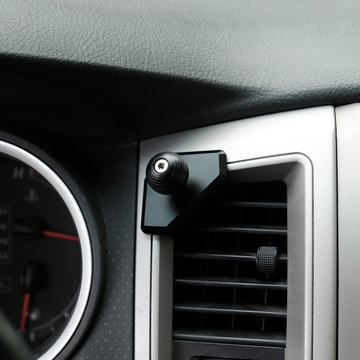 Image of Offroam Mounting Base installed securely in Toyota Tacoma 2005-2011. This premium all metal phone mounting base installs easily without drilling or glue. Perfect placement without blocking screens, driver view, or air flow.