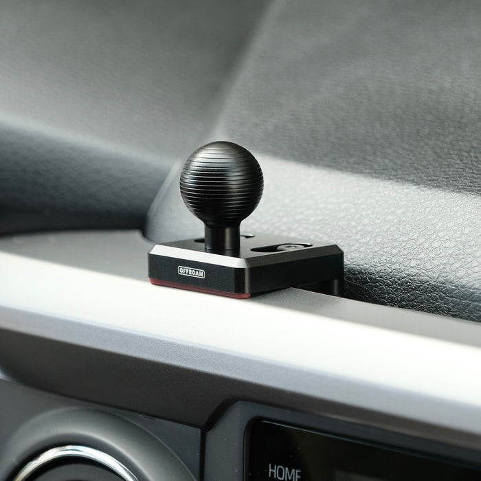 Image of Offroam Mounting Base installed securely in Toyota Tacoma 2016-2023. This premium all metal phone mounting base installs easily without drilling or glue. Perfect placement without blocking screens, driver view, or air flow.