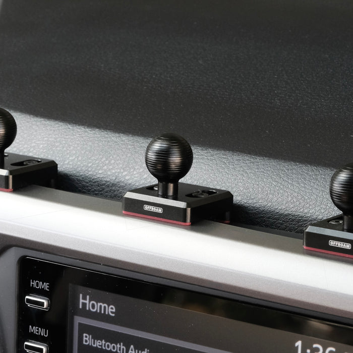 Image of Offroam Mounting Bases installed securely in Toyota Tacoma 2016-2023. This premium all metal phone mounting base installs easily without drilling or glue. Perfect placement without blocking screens, driver view, or air flow.