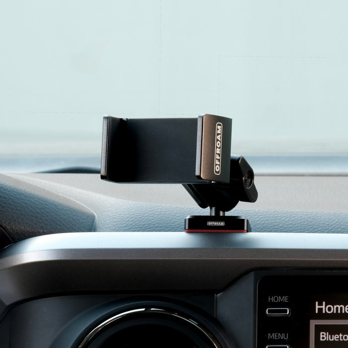 Image of Offroam Phone Mount installed securely in Toyota Tacoma 2016-2023. This premium phone mount installs easily without drilling or glue. Spring loaded Universal holder for use with any phone. Perfect placement without blocking screens, driver view, or air flow. Fully adjustable positioning.