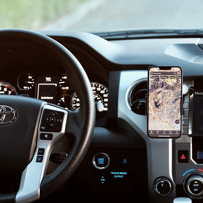 Image of Offroam Phone Mount installed securely in Toyota Tacoma 2016-2023 | Tundra 2014-2021. This premium phone mount installs easily without drilling or glue. Spring loaded Universal holder for use with any phone. Perfect placement without blocking screens, driver view, or air flow. Fully adjustable positioning.