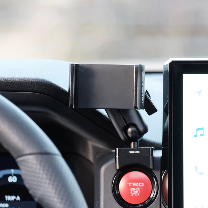 Image of Offroam Phone Mount installed securely in Toyota Tacoma 2024-2026 | 4Runner 2025-2026. This premium phone mount installs easily without drilling or glue. Spring loaded Universal holder for use with any phone. Perfect placement without blocking screens, driver view, or air flow. Fully adjustable positioning.