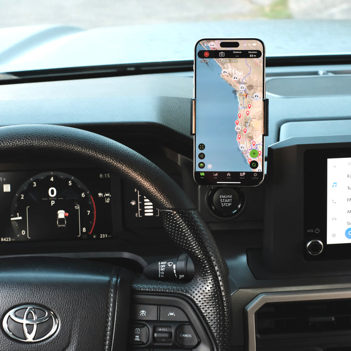Image of Offroam Phone Mount installed securely in Toyota Tacoma 2024-2026 | 4Runner 2025-2026. This premium phone mount installs easily without drilling or glue. Spring loaded Universal holder for use with any phone. Perfect placement without blocking screens, driver view, or air flow. Fully adjustable positioning.