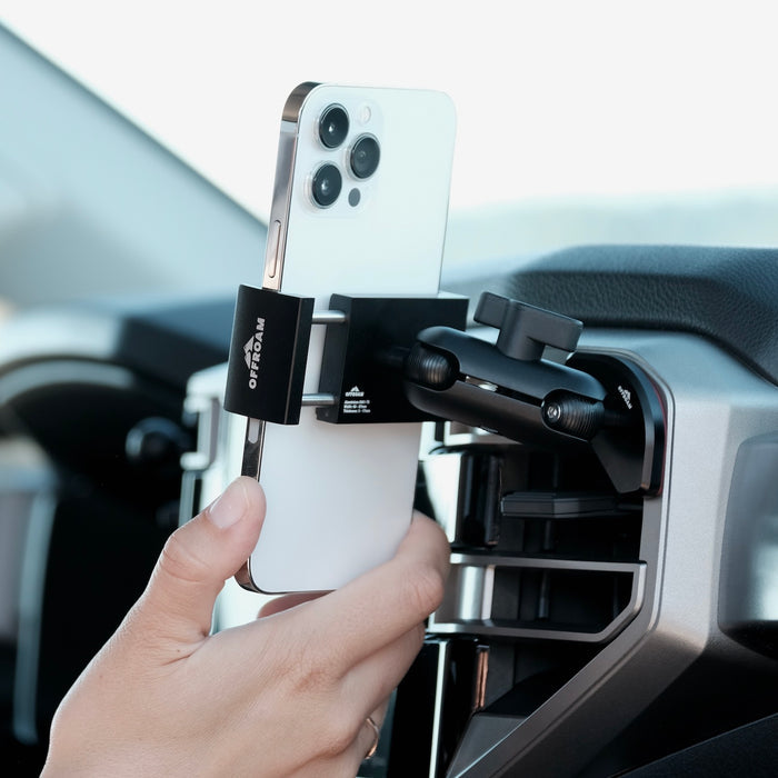 Image of Offroam Phone Mount installed securely in Toyota Tundra 2022-2026 | Sequoia 2023-2026. This premium phone mount installs easily without drilling or glue. Spring loaded Universal holder for use with any phone. Perfect placement without blocking screens, driver view, or air flow. Fully adjustable positioning.