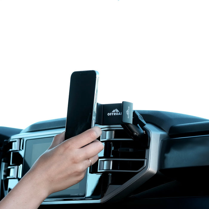 Image of Offroam Phone Mount installed securely in Toyota Tundra 2022-2026 | Sequoia 2023-2026. This premium phone mount installs easily without drilling or glue. Spring loaded Universal holder for use with any phone. Perfect placement without blocking screens, driver view, or air flow. Fully adjustable positioning.